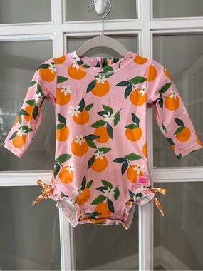 Ruffle Butts Pink Swimsuit with Orange Fruit Print